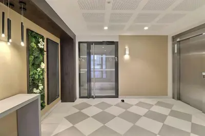 an office lobby with a glass door and a checkered floor at Appartement moderne - Terrasse - Piscine - Parking in Ventabren