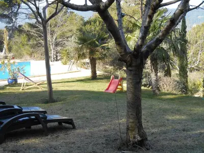 a tree with a swing in a park at Villa Boulou in Rognes