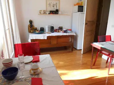 a kitchen with a table and a white refrigerator at Villa Boulou in Rognes