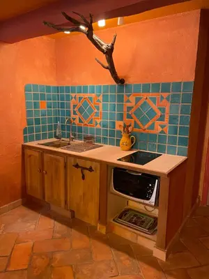 a kitchen with a sink and a stove top oven at Charmant duplex bucolique, piscine, en Provence in Le Beaucet
