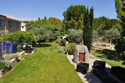 a garden with a stone fireplace and a yard at Charmant duplex bucolique, piscine, en Provence in Le Beaucet