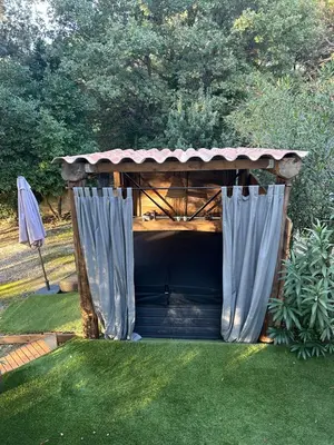a gazebo with a shelter in a yard at Cocon cosy appart romantique, jacuzzi piscine in Puget