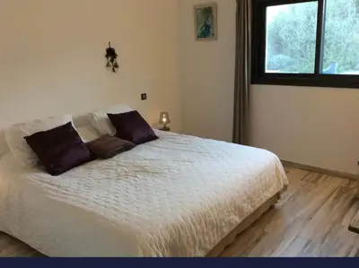 a bedroom with a white bed with two pillows on it at Villa aloha in Saint-Rémy-de-Provence