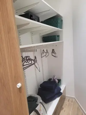 a walk in closet with hangers and bags at Appartement Au cœur de l'Isle in LʼIsle-sur-la-Sorgue