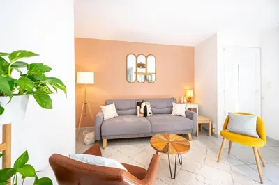 a living room with a couch and a table at Ô Cocon Provençal in LʼIsle-sur-la-Sorgue