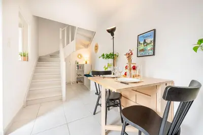 a dining room with a wooden table and chairs at Ô Cocon Provençal in LʼIsle-sur-la-Sorgue