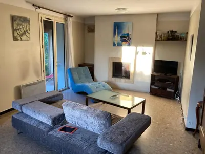 a living room with a couch and two chairs and a table at Villa 10 mins a pieds du centre de L Isle sur la Sorgue in LʼIsle-sur-la-Sorgue