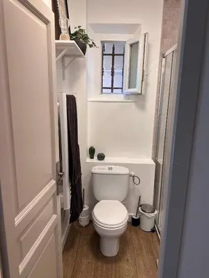 a small bathroom with a toilet and a window at Appartement clim & piscine sur Golf in Pont-Royal en Provence