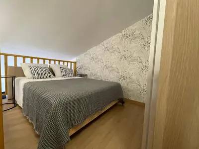 a bedroom with a bed with a comforter on it at STUDIO campagne Les Clapiers AIX EN PROVENCE in Aix-en-Provence