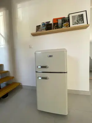 a white refrigerator in a room with a shelf at STUDIO campagne Les Clapiers AIX EN PROVENCE in Aix-en-Provence