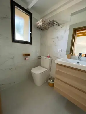 a bathroom with a toilet and a sink and a window at STUDIO campagne Les Clapiers AIX EN PROVENCE in Aix-en-Provence