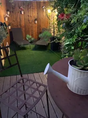 a patio with a chair and a table with a potted plant at Un havre de paix au coeur de la Provence in Châteaurenard