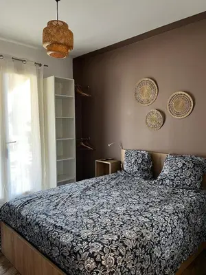 a bedroom with a bed with a blue comforter at Chambre d hôtes chez l habitant in Velaux