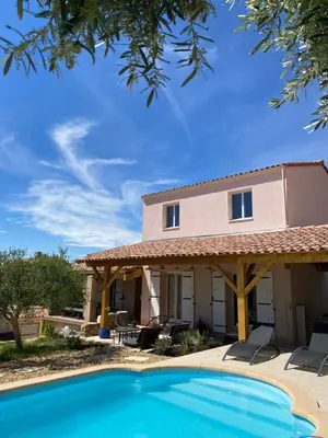 a house with a swimming pool in front of a house at Chambre d hôtes chez l habitant in Velaux