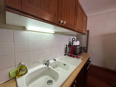 a kitchen counter with a sink and a mirror at Chez Florence - Appartement T2 d au cœur du centre ville historique - Proche Cardeurs et Mairie in Aix-en-Provence