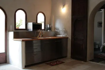 a kitchen with a counter with a sink and a microwave at Les Gites de Catherine in Gargas