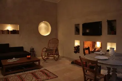 a living room with a couch and a table and a fireplace at Les Gites de Catherine in Gargas