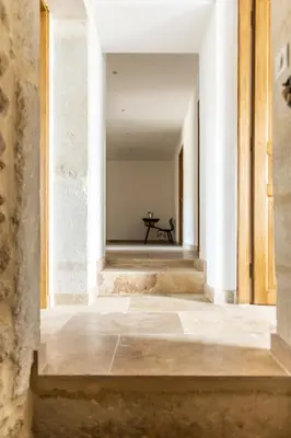 an empty hallway with a table in the distance at Mas mes Aïeux in Saint-Rémy-de-Provence