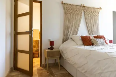 a bedroom with a bed and a mirror at Mas mes Aïeux in Saint-Rémy-de-Provence