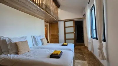a bedroom with two beds with towels on them at Mas mes Aïeux in Saint-Rémy-de-Provence