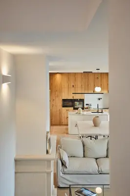 a living room with a couch and a kitchen at TERRE UGO - Villa & Suites au cœur des lavandes de Provence in Aix-en-Provence