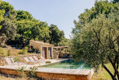 a villa with a swimming pool and a house at La canopée, Bastide sur les hauteurs de Lourmarin in Lourmarin