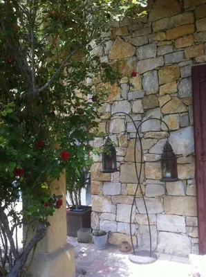 a stone wall with two lights on a building at Gite au coeur de la Provence & SPA in Saint-Cannat