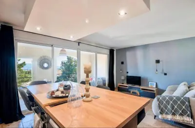 a living room with a table and a couch at appartement pont royal in Mallemort