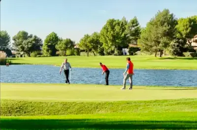 a group of people playing golf on a golf course at appartement pont royal in Mallemort