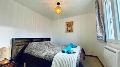a bedroom with a bed with blue towels on it at Rendez-vous en Provence -10 personnes- duo de gîtes- piscine privée - clim in Cheval-Blanc