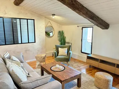 a living room with a couch and a table at Le Scandinave in Aix-en-Provence