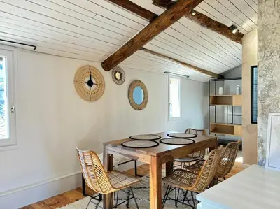 a dining room with a wooden table and chairs at Le Scandinave in Aix-en-Provence