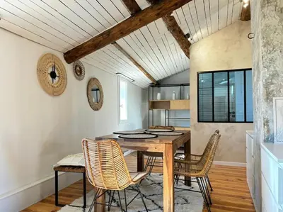 a dining room with a wooden table and chairs at Le Scandinave in Aix-en-Provence