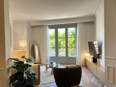a living room with a large window and a couch at Le Pénélope in Aix-en-Provence