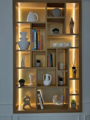 a wooden book shelf with dishes and books at Le Pénélope in Aix-en-Provence