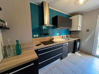 a kitchen with blue walls and wooden counter tops at La Villa Nawengo in Le Thor