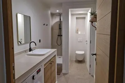 a bathroom with a sink and a toilet and a mirror at Appartement Indépendant avec Jardin et Piscine en Provence in Ventabren