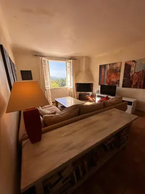 a living room with two couches and a table at Les 3 Terrasses in Roussillon