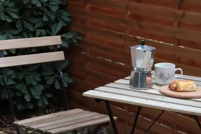 a table with a coffee maker and a cup of coffee at Studio Soléa - Studio 2 - 4 personnes - Domaine Astra, Grans in Grans