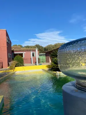 a pool of water in front of a house at La Villa Astra de 4 à 12 personnes - Domaine Astra, Grans in Grans