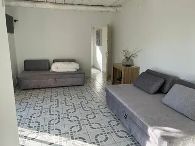 a living room with a bed and a couch at La Maison Alma - de 4 à 12 personnes - Domaine Astra, Grans in Grans