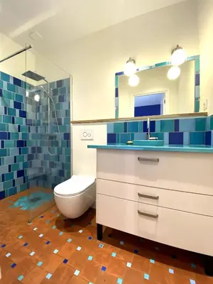 a bathroom with a sink and a toilet and a mirror at Le grand mas du Couchadou in Pernes-les-Fontaines