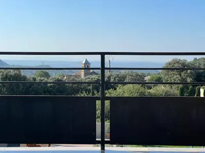 a view of a building through a window at L'appart du mas du Zébu Bleu in Vernègues