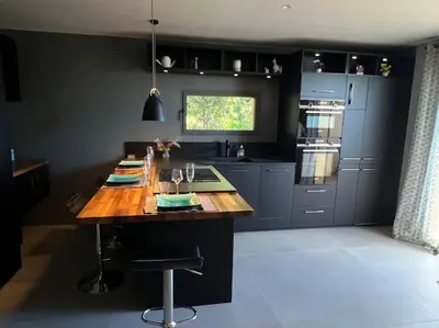 a kitchen with a wooden table in a kitchen at L'appart du mas du Zébu Bleu in Vernègues
