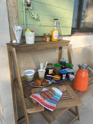 a wooden table with food on a table at Au Clair Ventoux B & B - SPA in Saint-Didier