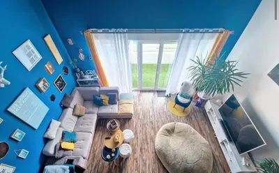 a living room with a couch and a window at Magnifique Duplex à proximité Aix en Provence in Éguilles