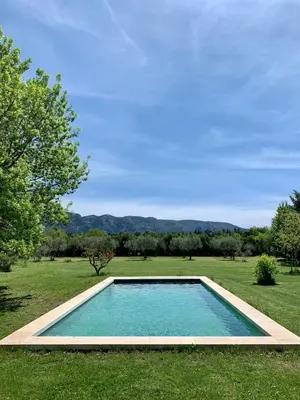 a swimming pool in the middle of a grass field at House with swimming pool and breathtaking views of the Luberon in Robion en Luberon