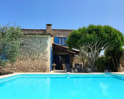 a large blue swimming pool in front of a house at 