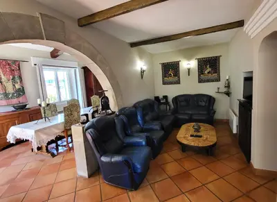a living room with black leather furniture and a table at 