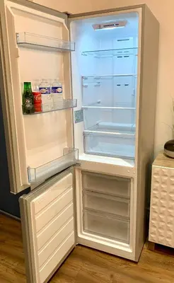 an empty refrigerator with its door open in a kitchen at Rotonde, 2 chambres, Air conditionné in Aix-en-Provence
